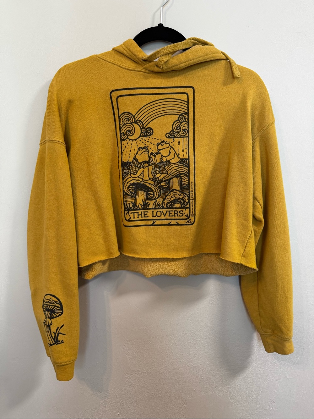 Mustard yellow hoodie with tarot card “the lovers” frogs reading on mushrooms